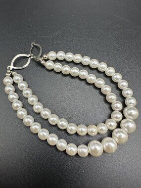 Elegant double strand faux pearl bracelet featuring ivory-colored graduated bead